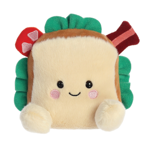 Kuscheliges Sandwich-Kissen mit einem lächelnden Gesicht, grünen Blättern und bunten Zutaten wie Speck und Champignons.