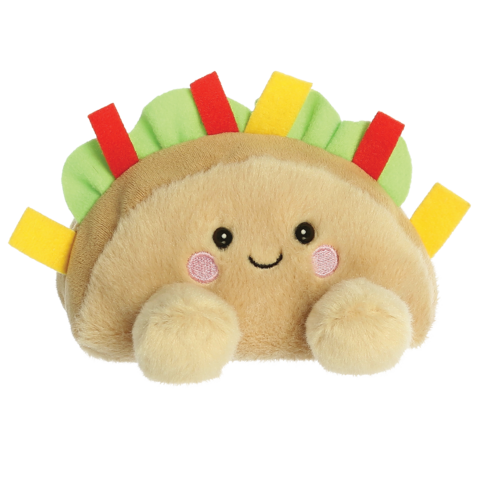 Kuscheltier in Form eines Taco mit einem lächelnden Gesicht, bunten Zutaten und weichem Material.