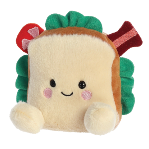 Kuscheliges Sandwich-Plüschtier mit einem lächelnden Gesicht, grünen Blättern sowie roten und braunen Akzenten.