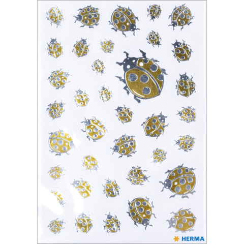 Eine Sammlung von Aufklebern mit verschiedenen Marienkäfern in Gold- und Grautönen auf weißem Hintergrund.
