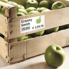 Kiste mit Granny Smith Äpfeln, Preis € 3,99 pro Pfund, einige Äpfel sichtbar, Holzstruktur der Kiste.