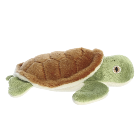 Plüschschildkröte mit braunem Panzer und grünen Flossen, liegend auf einer flachen Oberfläche.