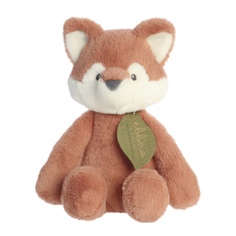 Kuscheltier in Form eines Fuchses mit braunem Fell und weißen Akzenten, trägt ein grünes Etikett.