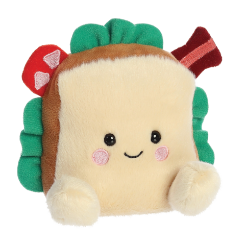 Kuscheliges Sandwich-Kissen mit einem lächelnden Gesicht, grünen Blättern und einer roten Zutat, die an Speck erinnert.